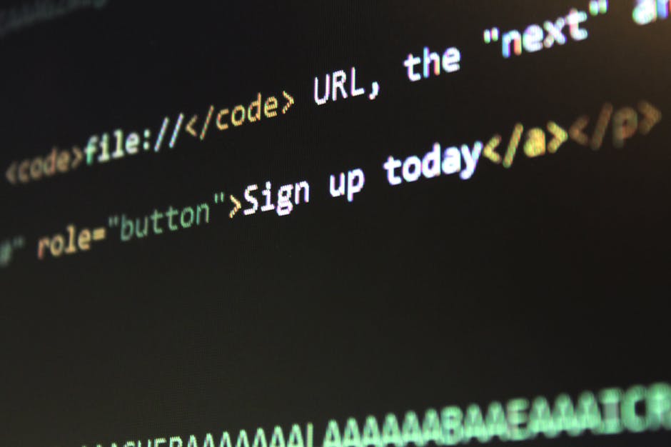 Close-up image of a laptop keyboard and screen displaying lines of code, with the code window open. The screen shows a dark background with colorful syntax highlighting for programming language, while